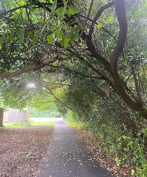 1.5 paved walking trail steps away from outside fence door.