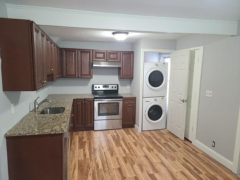 Renovated kitchen with stainless steel appliances, laundry, and plenty of counter space and cabinets for storage