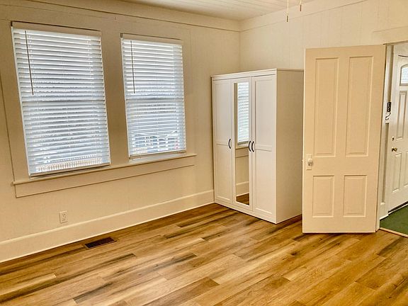 3511 Crompton - Bedroom 1. Features fireplace (nonworking), bookcase, and wardrobe with tons of storage. LVP flooring, 3 windows for great natural light. New blinds. Large enough for king size bed.