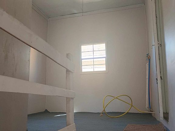 Landing Outside inner doorway to apartment with laundry hook ups