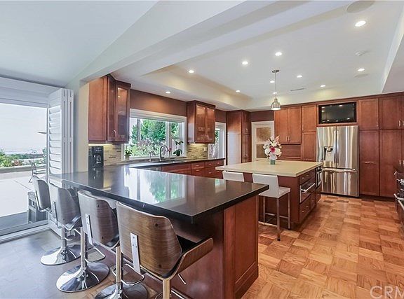 Beautifully remodeled gourmet kitchen (2014) top of the line appliances, Caesar stone counters, ocean, city lights, and mountain views form the picture window and the sliding glass doors.
