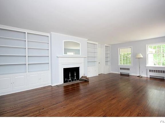Living Room with built in bookcases and wood burning fireplace.