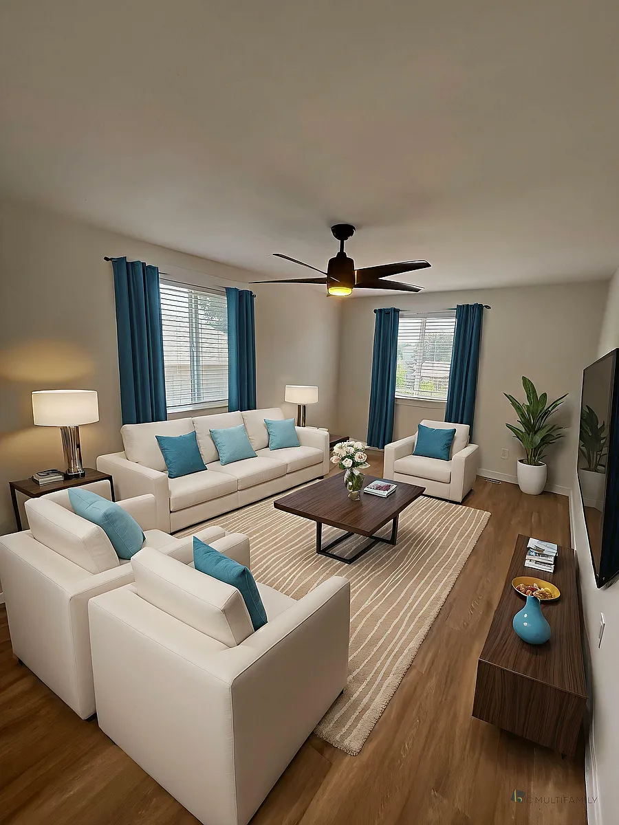Inviting living room with modern white sofas, vibrant blue accents, and elegant wooden furniture, perfect for relaxing and entertaining. - 212-218 Longs Peak