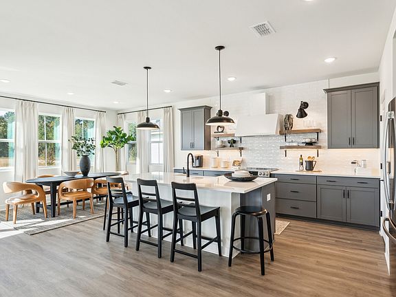 Kitchen with pendant lighting floating shelves