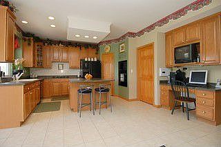 Kitchen w center island and planning desk.