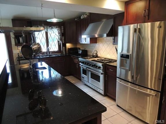 Kitchen spacious work area with granite counters and upscale stainless appliances