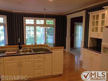kitchen looking to back yard and sun room to right.