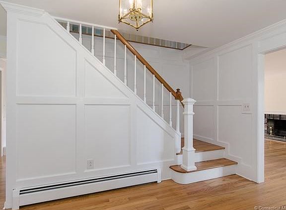 Large and inviting front foyer. Notice the exquisite finishes such as crown molding and wainscoting. Wood floors are throughout the home and have been refinished.