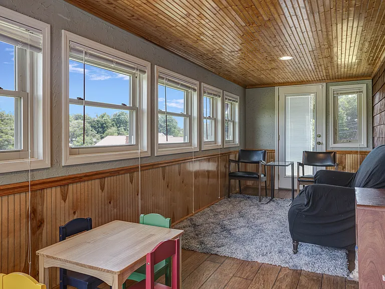 Multipurpose room, opens to the side porch. This space is not temperature controlled.