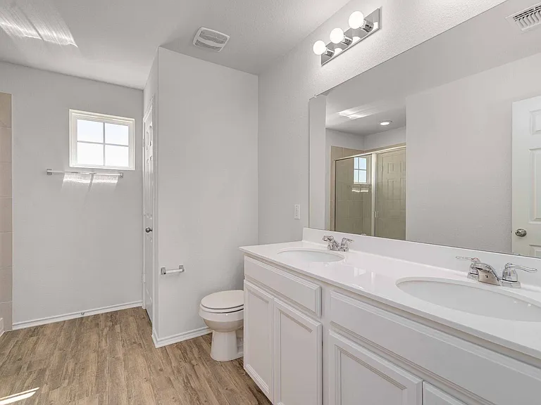 Primary bathroom with double vanity sinks & walk in shower