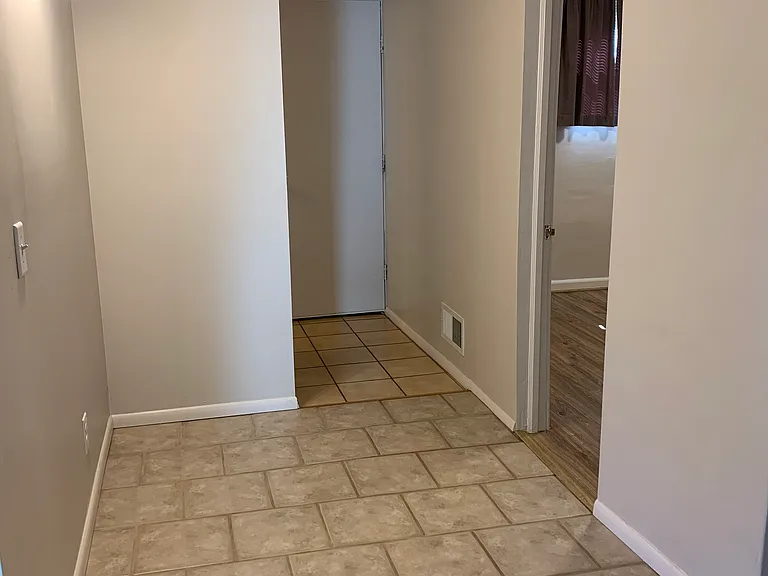 Hallway leading to bedroom, bathroom and garage
