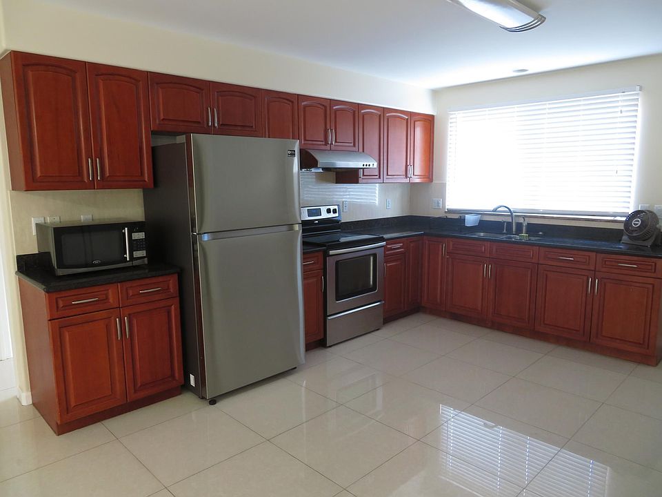 Kitchen with microwave, new refrigerator, stove and new blinds.