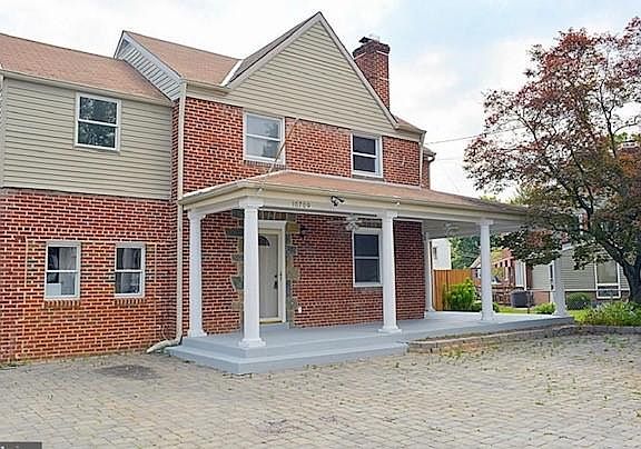 Front of House w/ 5 car brick Driveway