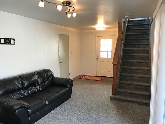 Entrance foyer to house and garage access door. staircase goes to 2nd level,