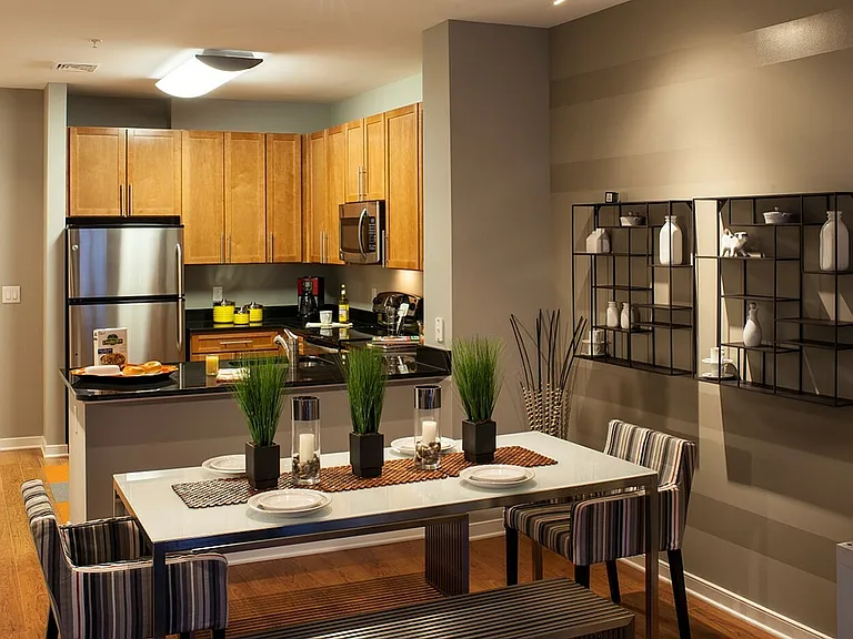 Dining Area & Contemporary Kitchen With Wood Cabinets & Stainless Steel Appliances
