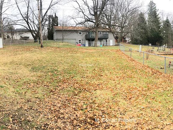 Panorama of large fenced back yard; shed & firepit