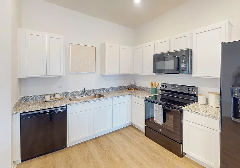 Kitchen
A thoughtfully designed kitchen features wraparound countertops and designer-selected cabinets for ease of use.