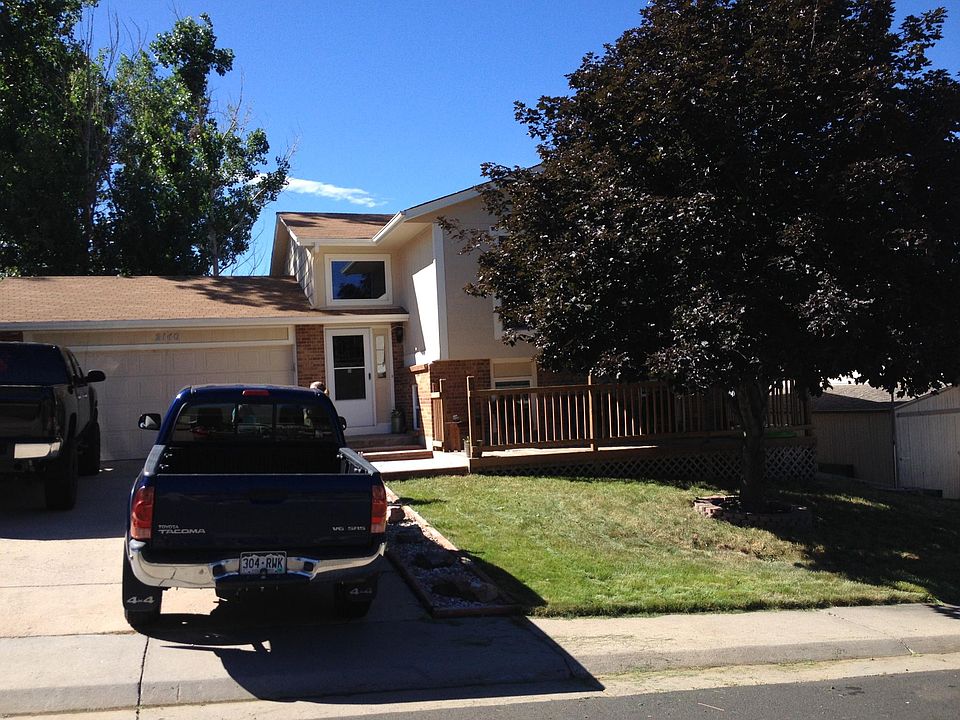 Front yard with Large 2 car garage that has cabinets and shelves.