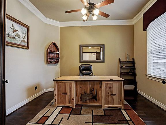 Great size study with glass doors, crown molding, and ceiling fan!