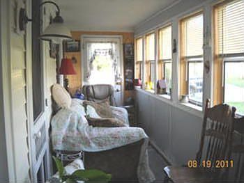 If you step to the front of the home you will get a view the lovely enclosed porch for relaxing and 