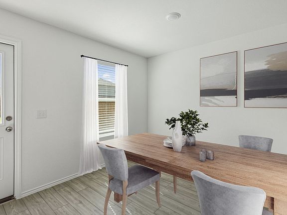 Airy dining area off of kitchen model representation
