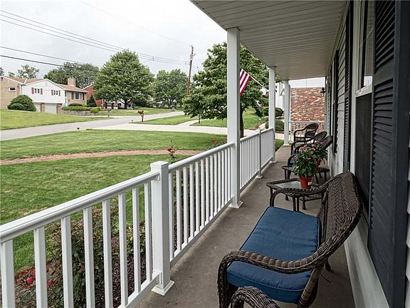 Greet guests on the expansive front porch.