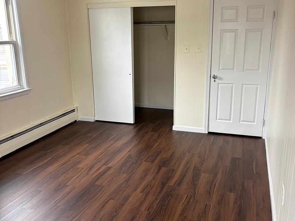 Bedroom #1 with new floor and plenty of sunlight7 Large Closet
