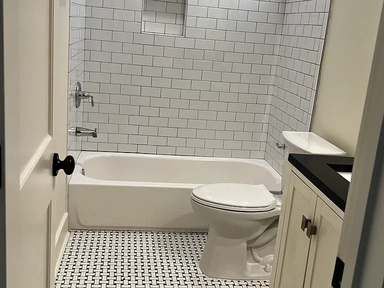 Hall tub bath with additional entry from front bedroom