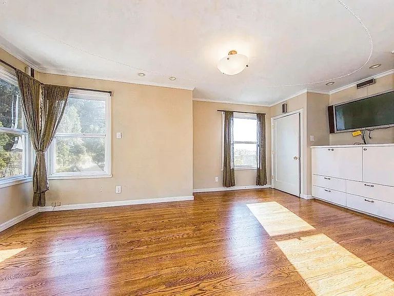 Master suite bedroom on 2nd floor overlooking garden, w/ two large closets and built in cabinets in room pictured, plus a walk in closet area with two additional closets + vanity desk area w/ window connecting master bathroom. House delivered unfurnished.