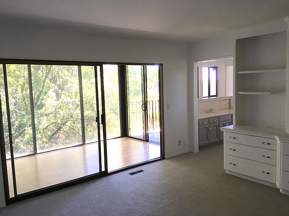 On 2nd floor down: Master Bedroom Suite with built-in dresser & shelves, adjacent Sunroom with lower balcony access, Bathroom sink and (not shown: walk-in closet, bathtub with a view, and private toilet).