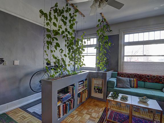 This is the front entry and the living room with a built in teal couch.