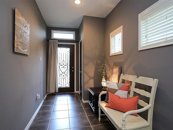 Light and bright tiled entry with coat closet.