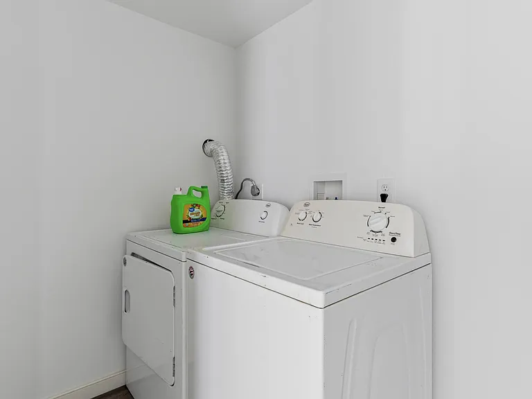 Dedicated laundry area with side-by-side washer and dryer for convenient in-home laundry days.