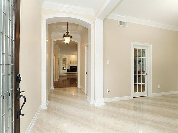 Gorgeous Polished Travertine Tile in Entryway and...