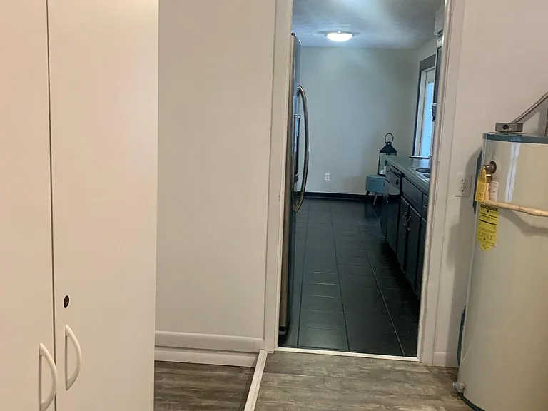 utility room looking into kitchen- new water heater