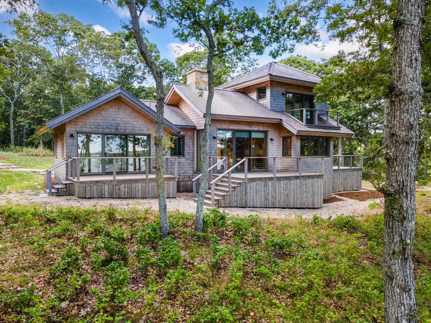  Back of house that faces the water with multiple decks