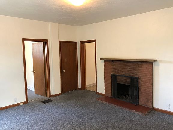 View of living room looking to fireplace, 2nd bedroom, bathr