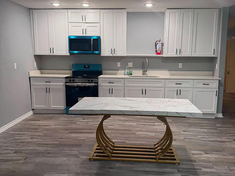Updated kitchen with shaker cabinetry, generous counter space, and stainless appliances plus an island-ready open layout.