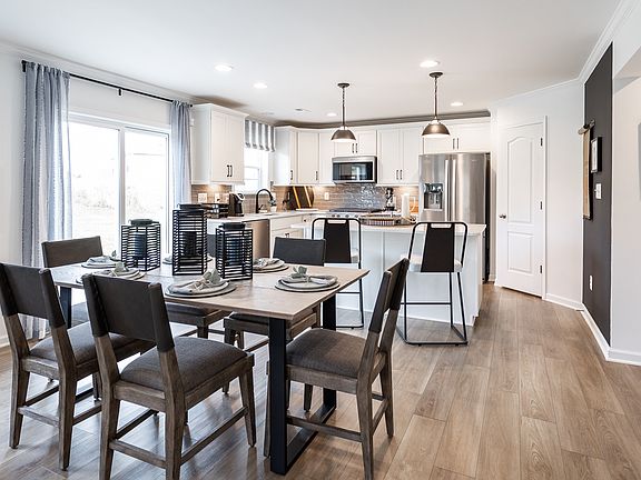 Open kitchen and adjoining breakfast area in a DRB Homes Carnegie II model in the Chesterfield commu