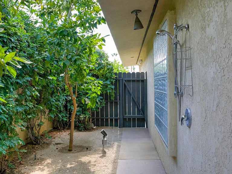 Outdoor shower and citrus trees.