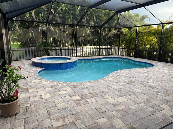 Pool with Hot tub also showing privacy from palms on sides and back