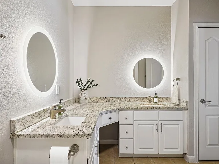 Bath with white cabinetry, speckled granite countertops, and hard surface flooring