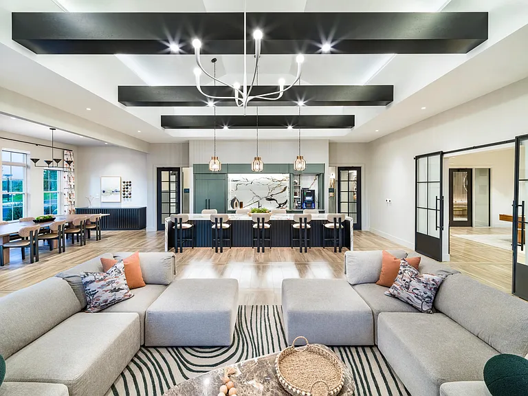 Bold beams, designer lighting, and curated textures set the tone for refined community spaces at Modera South Shore in Marshfield, MA.