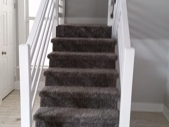 Stairs leading to upstairs loft bedroom and full bathroom 