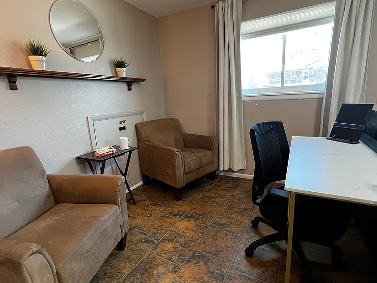 Dedicated workspace with a cozy reading nook, perfect for remote work, study, or quiet downtime.