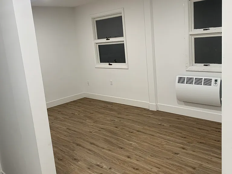 Living area with high-efficiency heaters. Plenty of sunlight with windows facing Main Street.