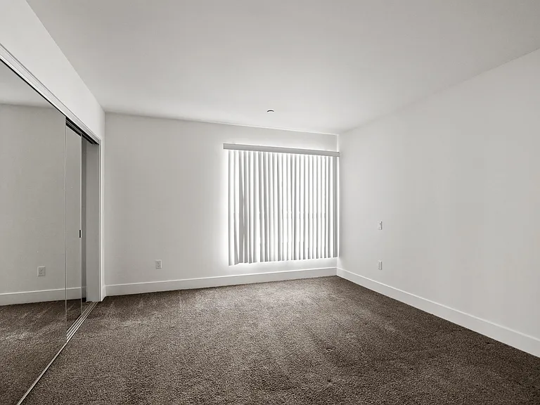 Bedroom with Large Window and Double-Door Closet