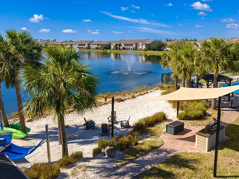 Enjoy a private lakeside retreat with hammocks, a fire pit, and a grilling station, all steps from your apartment home.
