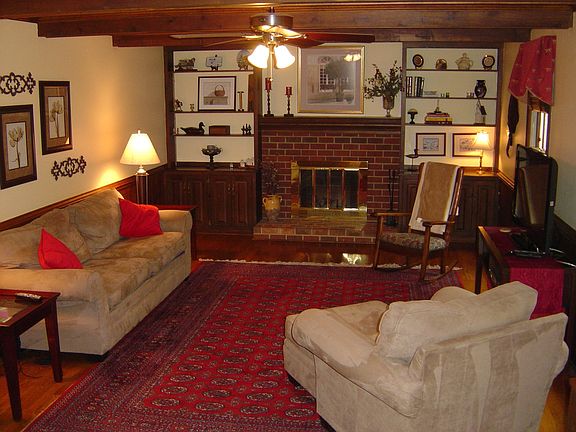 Family room w exposed beams and brick fireplace
