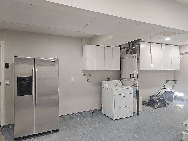 The garage has a large second fridge. Washer and Dryer included (washer has been added). Epoxied floors for clean laundry area. Oodles of storage cabinets.